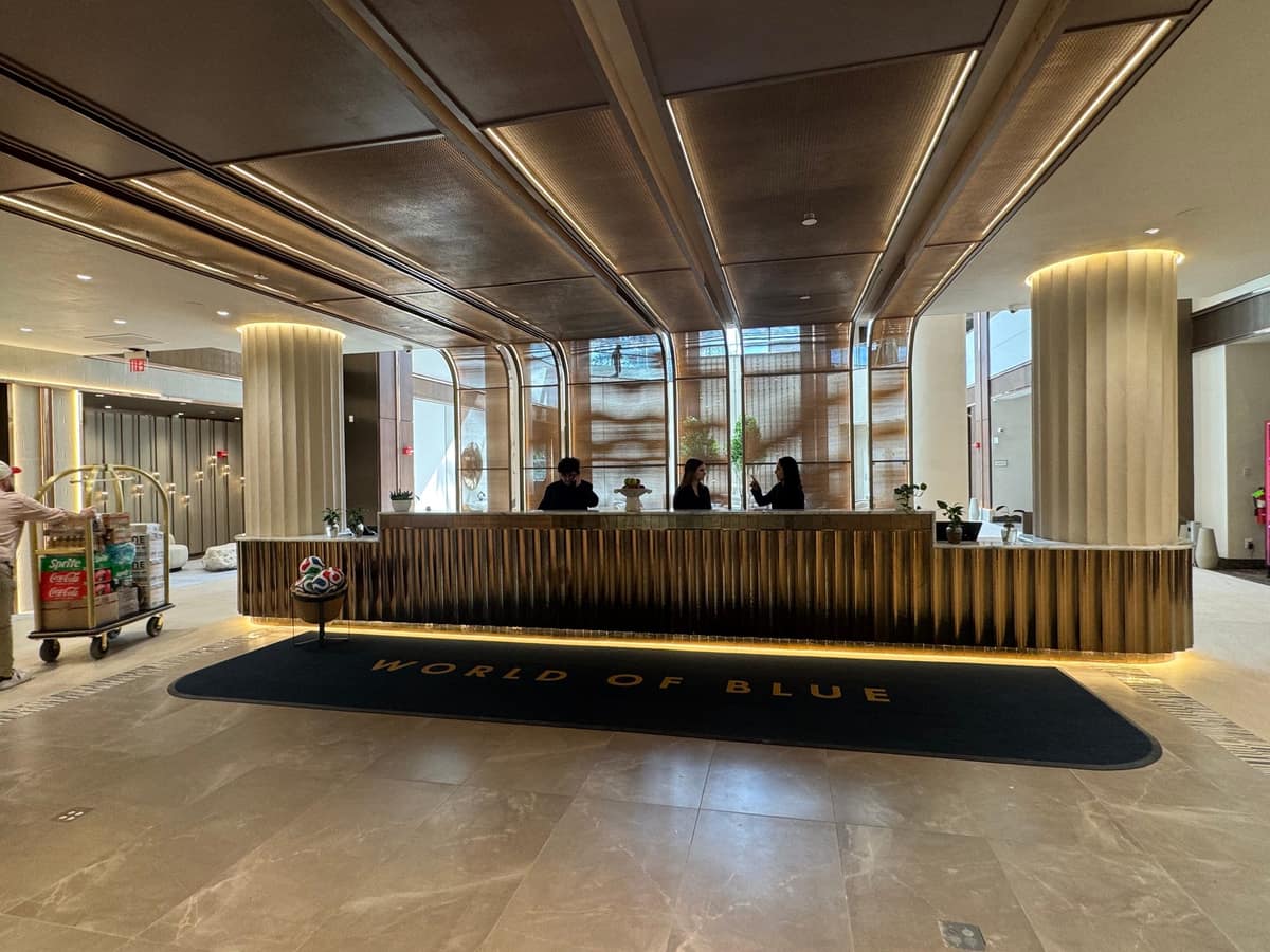 A guest checking in at the World of Blue front desk