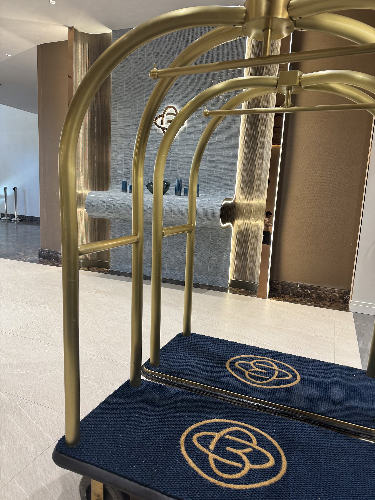 A brass luggage cart with the World of Blue mark