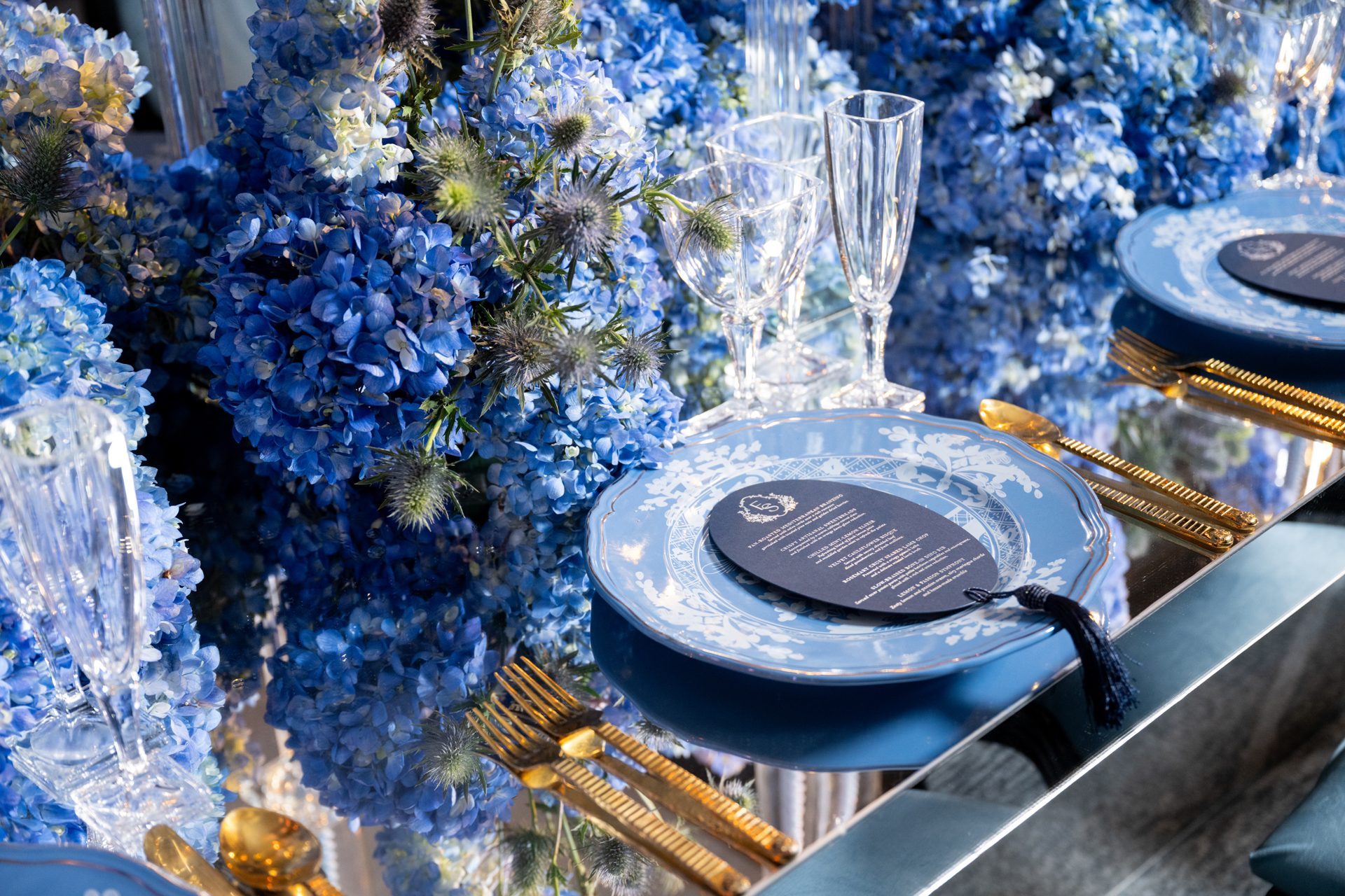 A blue hydrangea tablescape with gold flatware
